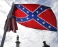 A protester waves a Confederate battle flag in front of the South Carolina statehouse, Thursday, July 9, 2015, in Columbia, S.C. More than 50 years after South Carolina raised a Confederate flag at its Statehouse to protest the civil rights movement, the rebel banner is scheduled to be removed Friday morning during a ceremony. (AP Photo/John Bazemore)