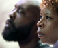 Parents of Michael Brown, Michael Brown Sr. and Lesley McSpadden listen to a speaker during a rally, Sunday, Aug. 17, 2014, for their son who was killed by police last Saturday in Ferguson, Mo. Brown's shooting in the middle of a street, following a suspected robbery of a box of cigars from a nearby market, has sparked a week of protests, riots and looting in the St. Louis suburb. (AP Photo/Charlie Riedel)